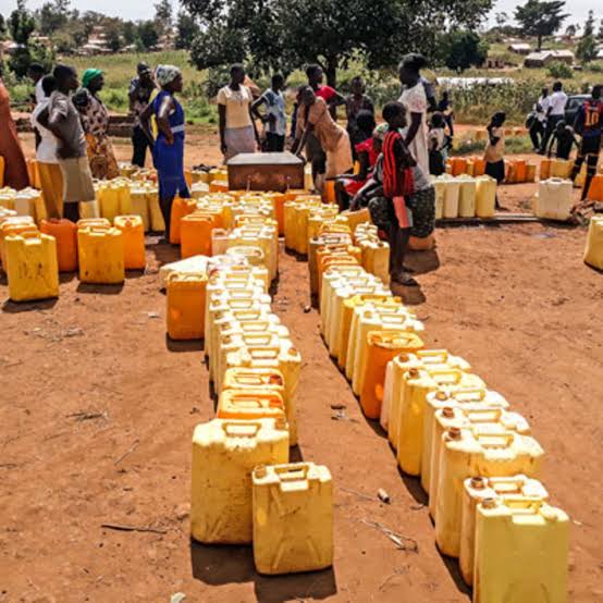 Jerrycans lined up as community members wait to collect water