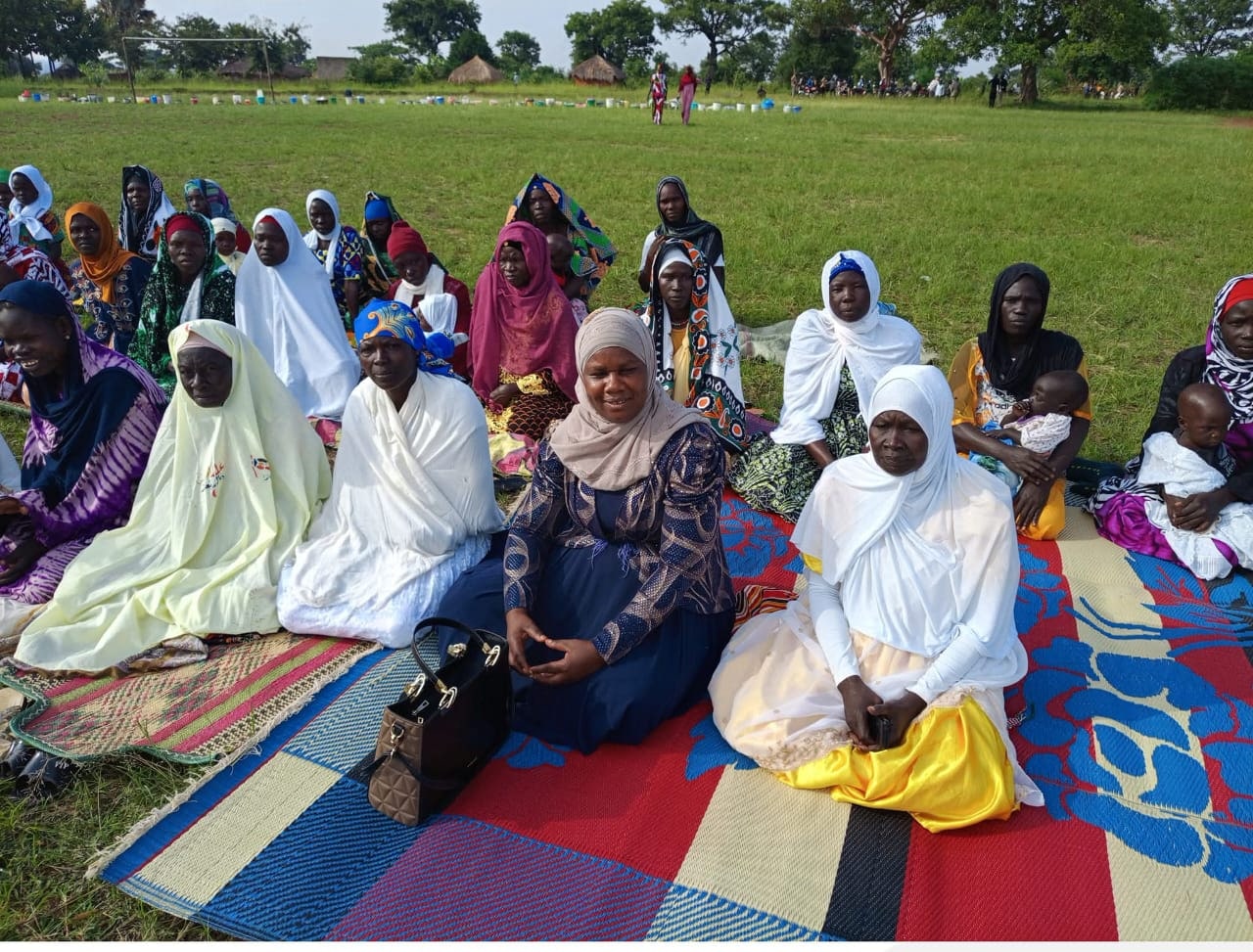 Women seated together during an IDPN community session in Yumbe District